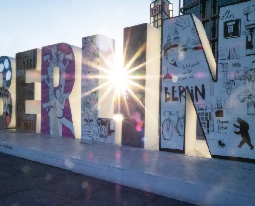 a large sign with a sun shining through it